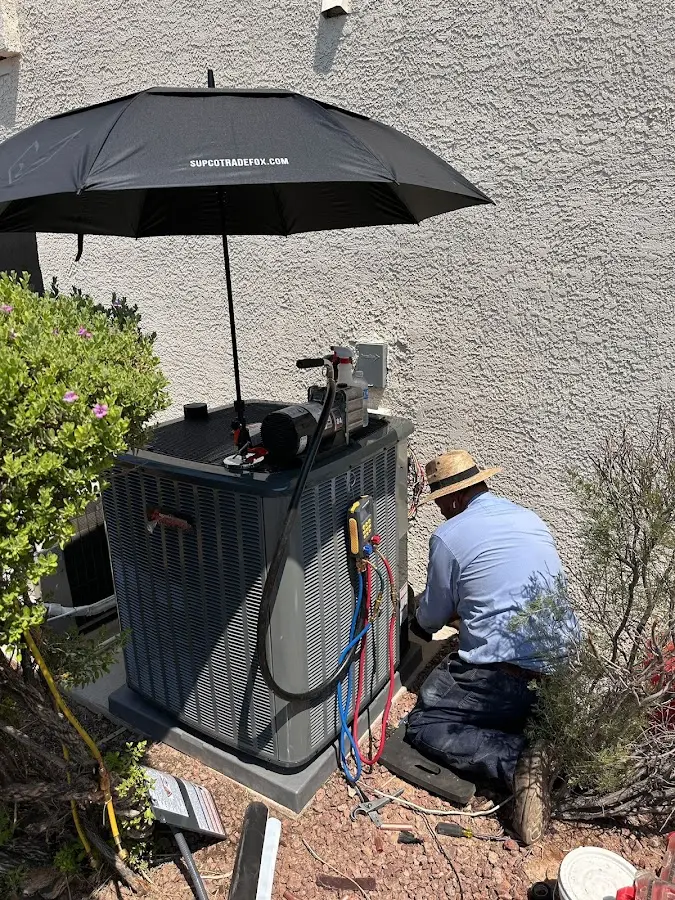 HVAC technician performing outdoor AC maintenance in Mentor-on-the-Lake